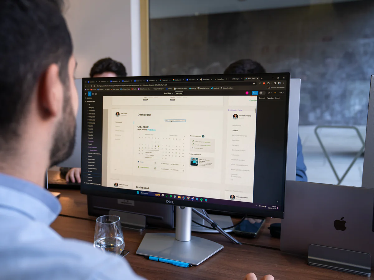 An AppX developer looking at a client dashboard on a large monitor
